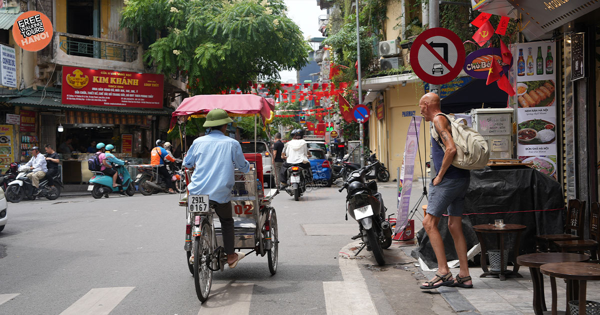A quiet Hanoi courtyard with laundry drying and bonsai trees.